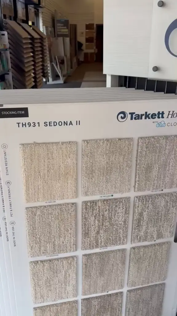 Close-up from the real Showroom Flooring showroom video showing actual carpet colour and texture samples on a Tarkett Home display